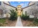 Townhouse exterior showcasing manicured bushes and a walkway leading to the entrance, with a bright blue sky overhead at 9654 Martin Luther King Jr Blvd, Denver, CO 80238