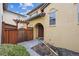 Charming front entrance with a wooden gate, stucco exterior, and well-kept landscaping at 9654 Martin Luther King Jr Blvd, Denver, CO 80238