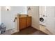 Carpeted hallway featuring storage and a laundry room with a modern washing machine at 9654 Martin Luther King Jr Blvd, Denver, CO 80238