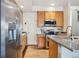 Bright kitchen with stainless steel appliances, granite countertops, and warm wood cabinetry at 9654 Martin Luther King Jr Blvd, Denver, CO 80238