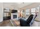 Cozy living room featuring a fireplace, TV, sleek furniture, and natural light streaming through the windows at 9654 Martin Luther King Jr Blvd, Denver, CO 80238