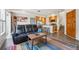 Open-concept living space featuring a modern kitchen, a cozy living room area, and easy access to the staircase at 9654 Martin Luther King Jr Blvd, Denver, CO 80238