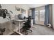 Office space featuring a dedicated desk and chair with a view from a large window at 9654 Martin Luther King Jr Blvd, Denver, CO 80238