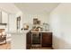 Stylish wet bar featuring stone countertop, wooden cabinets and wine refrigerator at 24 Spyglass Dr, Littleton, CO 80123