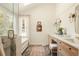 Bathroom features a vanity, tub, and a window allowing for natural light at 24 Spyglass Dr, Littleton, CO 80123