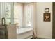 Elegant bathroom features a tub, and a window allowing for natural light at 24 Spyglass Dr, Littleton, CO 80123