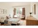 Sun-lit bedroom features neutral furniture, a window and hardwood floors at 24 Spyglass Dr, Littleton, CO 80123