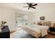 Comfortable bedroom offers a ceiling fan, sliding glass door, and calming design at 24 Spyglass Dr, Littleton, CO 80123