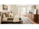 Bedroom features a large window, neutral color palette, and hardwood floors at 24 Spyglass Dr, Littleton, CO 80123
