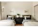 Charming bedroom with two beds, playful decor, and stylish symmetry at 24 Spyglass Dr, Littleton, CO 80123