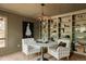 Dining room with a marble table, cushioned chairs, built-in shelving, and hardwood floors at 24 Spyglass Dr, Littleton, CO 80123
