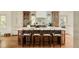 Spacious kitchen with island seating, custom cabinets, marble countertops, and stainless appliances at 24 Spyglass Dr, Littleton, CO 80123