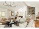 Bright, open-concept living room with modern lighting, hardwood floors and staircase at 24 Spyglass Dr, Littleton, CO 80123