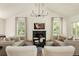 Bright living room boasts vaulted ceilings, cozy seating around a fireplace, and natural light at 24 Spyglass Dr, Littleton, CO 80123