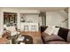 Open-concept living area with access to a bar area and hardwood floors at 24 Spyglass Dr, Littleton, CO 80123