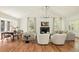 Open floorplan featuring a modern fireplace, ample seating, and a dining area in a naturally lit space at 24 Spyglass Dr, Littleton, CO 80123