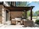 Outdoor brick patio features comfortable seating area, pergola, and well-maintained landscaping at 24 Spyglass Dr, Littleton, CO 80123