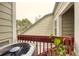 Private balcony with red railings, plants, and views of the surrounding trees at 919 S Dawson Way # 17, Aurora, CO 80012