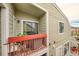 Private balcony with red railings and a seating area at 919 S Dawson Way # 17, Aurora, CO 80012