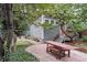 Stone patio with wooden bench and table in a backyard garden setting at 3824 Lowell Blvd, Denver, CO 80211