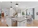 Open concept kitchen with island, stainless steel appliances, and white cabinets at 3824 Lowell Blvd, Denver, CO 80211