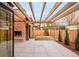 Spacious backyard with an outdoor fireplace, patio, wood fence, professional landscaping, and a timber pergola at 1968 S Washington St, Denver, CO 80210