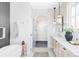 Bright bathroom with a free standing tub, glass shower and double sink vanity at 1968 S Washington St, Denver, CO 80210