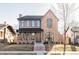 Stunning brick and wood two-story home featuring a charming front porch and architectural details at 1968 S Washington St, Denver, CO 80210