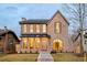Charming two-story brick home showcasing elegant architectural details, a welcoming front porch, and well-maintained landscaping at 1968 S Washington St, Denver, CO 80210