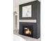 Modern fireplace with dark surround and light wood mantel at 1968 S Washington St, Denver, CO 80210