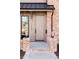 Beautiful wood front door flanked by brick accents and lantern-style lighting at 1968 S Washington St, Denver, CO 80210