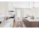 Spacious kitchen featuring a large island, stainless steel appliances, and hardwood floors at 1968 S Washington St, Denver, CO 80210