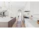 Open kitchen with large island, stainless appliances, and hardwood floors throughout the home at 1968 S Washington St, Denver, CO 80210