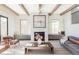 Cozy living room with fireplace, wood beams, and ample natural light at 1968 S Washington St, Denver, CO 80210