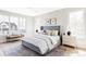 Serene main bedroom with neutral tones, large windows, and a comfortable seating area at 1968 S Washington St, Denver, CO 80210