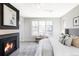 Comfortable main bedroom with a fireplace, neutral tones, and large windows at 1968 S Washington St, Denver, CO 80210