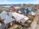 Aerial view showcasing the home's backyard, nearby houses, and neighborhood with mountain views at 2465 W Caithness Pl, Denver, CO 80211