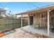 Back patio features outdoor seating, a wooden fence, string lights, and a covered area at 2465 W Caithness Pl, Denver, CO 80211