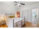 Bedroom with a decorative metal bed frame, wood floors, closet, and ample natural light at 2465 W Caithness Pl, Denver, CO 80211