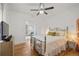 Bedroom featuring a metal bed frame, hardwood floors, and a view into the living room at 2465 W Caithness Pl, Denver, CO 80211