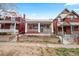 Charming single-story home, nestled between multi-story houses, with a cozy front porch at 2465 W Caithness Pl, Denver, CO 80211