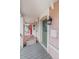 Charming front porch with gray-painted wood floors, a green front door, and stylish exterior lighting at 2465 W Caithness Pl, Denver, CO 80211