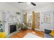 Bright living room features a decorative fireplace, custom book wall design, and a ceiling fan at 2465 W Caithness Pl, Denver, CO 80211