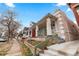 Quaint home with a covered porch situated on a tree-lined street near a sidewalk at 2465 W Caithness Pl, Denver, CO 80211
