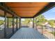 Spacious covered balcony featuring wood ceiling and composite deck boards with neighborhood views at 4452 Xavier St, Denver, CO 80212