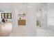 Bright bathroom hallway with storage cabinets, arch and shower with glass door at 4452 Xavier St, Denver, CO 80212