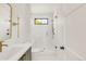 Stylish bathroom featuring a glass shower with gold hardware and elegant fixtures at 4452 Xavier St, Denver, CO 80212