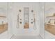 Stylish bathroom showcasing double showers, storage cabinets and archway in white tile at 4452 Xavier St, Denver, CO 80212