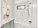 Bathroom featuring a glass shower, window, green vanity, and gold hardware at 4452 Xavier St, Denver, CO 80212