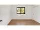 Bedroom featuring hardwood floors, natural light from window, and white closet doors at 4452 Xavier St, Denver, CO 80212